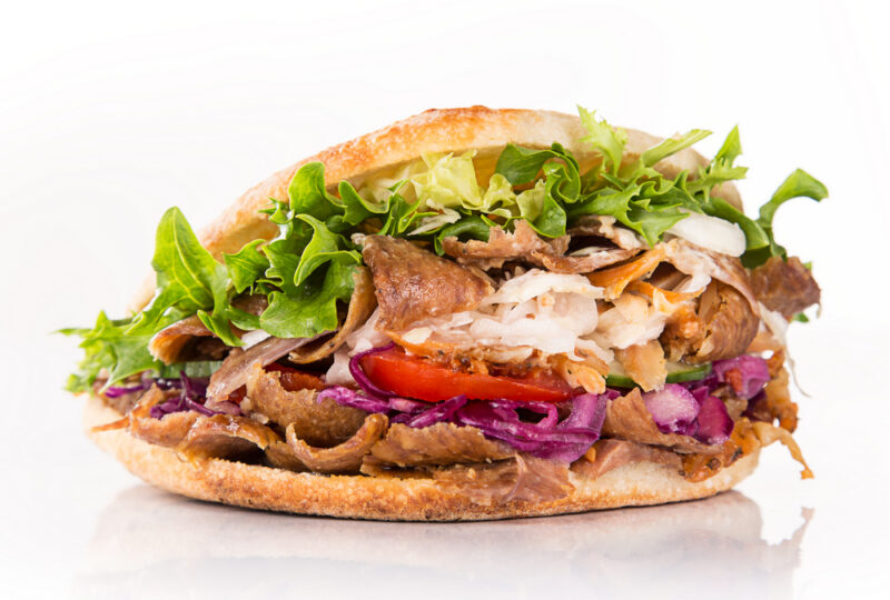 close up of kebab sandwich on white background